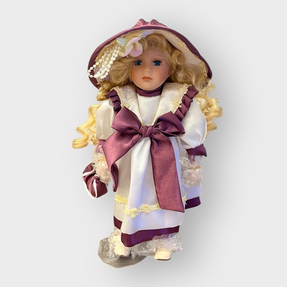 Kinnex Linda Porcelain Blonde Hair Blue Eyes Maroon Bow Dress Doll with Stand